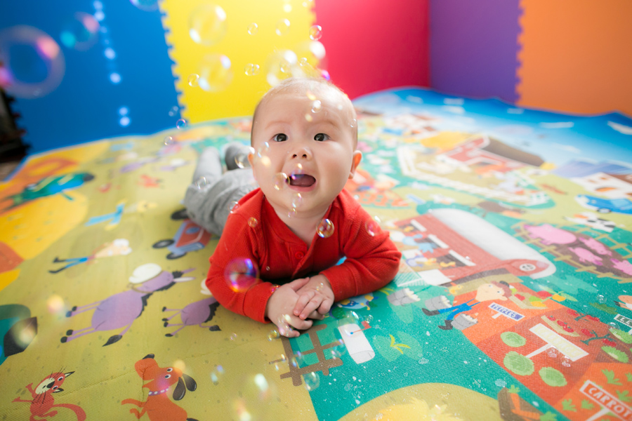 baby playing with bubbles